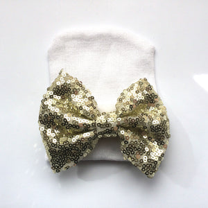 White hat-gold bow